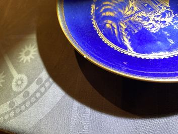 Four Chinese gilt-decorated blue-ground cups and saucers with fine landscapes, Qianlong